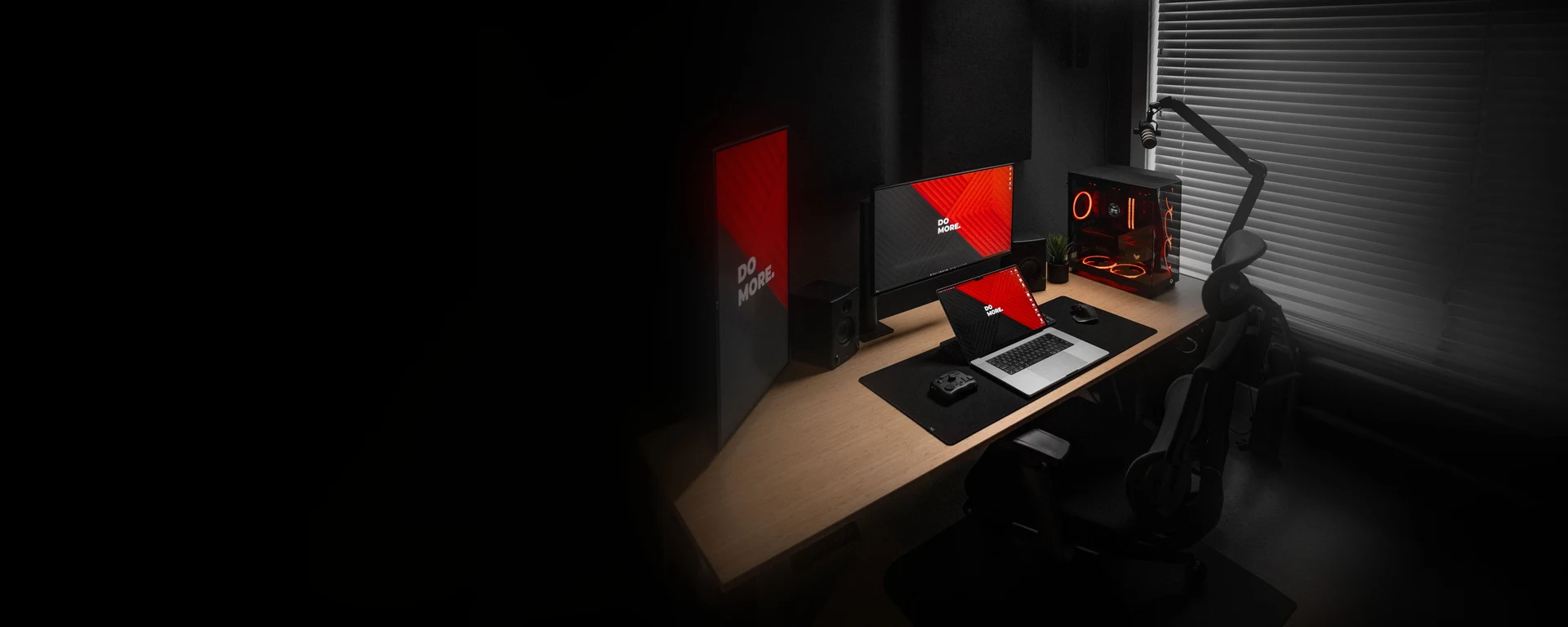 A desk setup with a Clean Desk Setup wallpaper